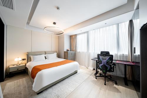 a bedroom with a large bed and a desk and a desk at Today Aparthotel West Lujiazui Shanghai in Shanghai