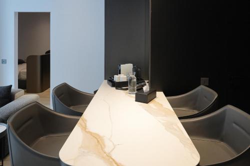 a long white table with chairs around it at Hotel Pestera Wellness & Spa in Sinaia