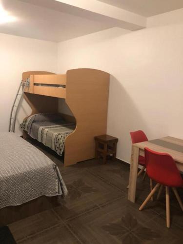 a bedroom with a bed and a desk and a table at Tonka Apartments in Zadar