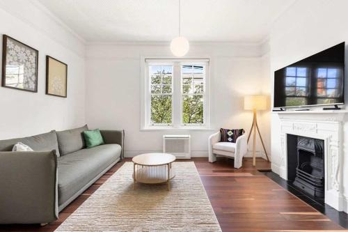 a living room with a couch and a fireplace at Urban Retreat Near Sydney Harbour in Sydney