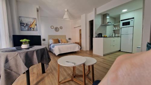 a room with a bed and a table and a kitchen at Perfect direct beach access in Benicàssim