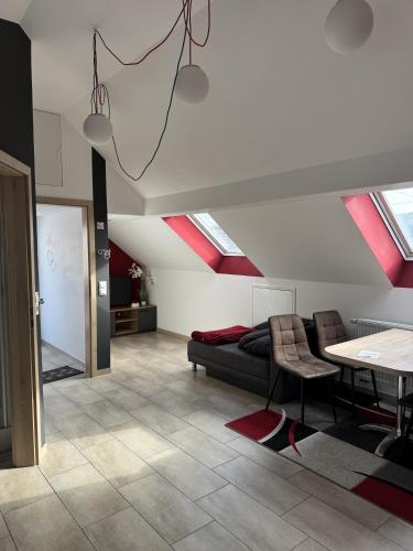 a living room with red ceilings and a couch and a table at Semihome in Dietingen