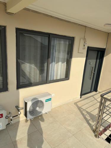 a room with a fan on the side of a building at AMS Global in Accra