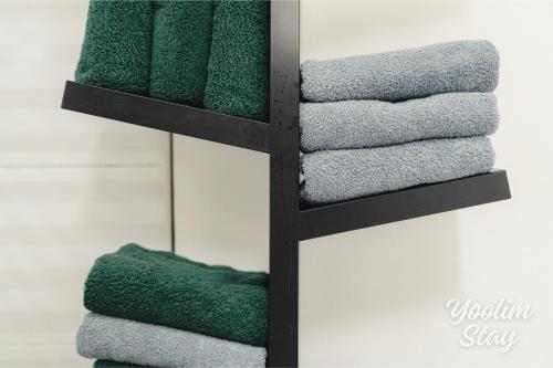 a pile of towels on a shelf in a bathroom at Yoolim stay # 건대입구# 성수# 잠실롯데타워 in Seoul