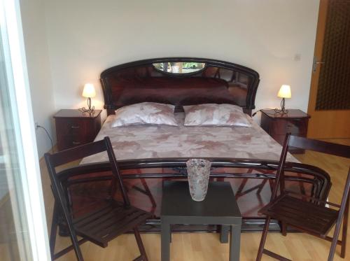 a bedroom with a bed with two chairs and a table at Apartment Paris with jacuzzi and sea view in Šmrika