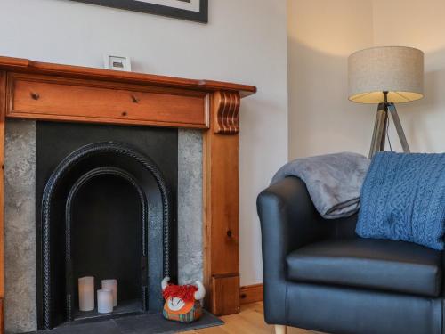 a living room with a chair and a fireplace at Bayview in Bragor