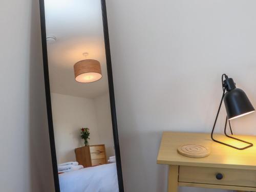 a mirror in a room with a bed and a desk at Bayview in Bragor