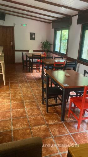 a dining room with wooden tables and chairs at Albergue O Beque in Moaña
