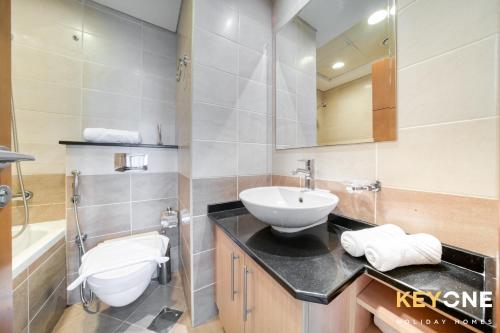 a bathroom with a sink and a toilet at Captivating Sky & Sea Views in Two Bedroom Suite in Dubai