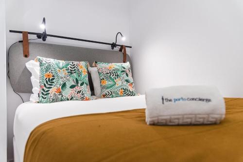a bed with two pillows and a pillow with the words fire put together at GuestReady - Easygoing Pool to River in Bandeira