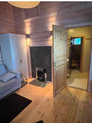 a living room with a fireplace and a couch at Villa Iltaranta - Cottage on the shore of Lake Saimaaa in Savonlinna