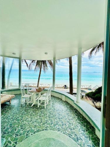 a house with a swimming pool next to the beach at Paradise Resort Doc Let - All Inclusive in Doc Let