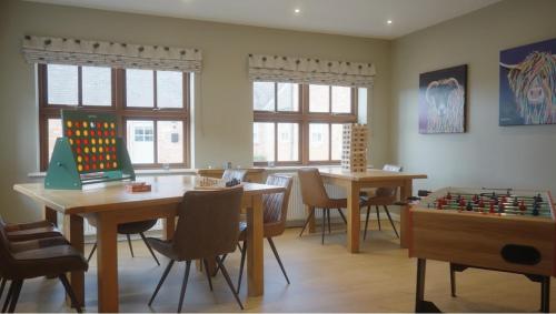 a room with two tables and a chess board at Wold Escapes, Highfield Farm in Great Driffield