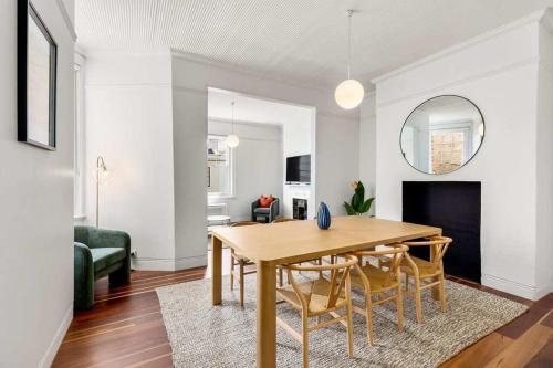 a living room with a wooden table and chairs at Perfect Vacation Home in Dawes Point in Sydney
