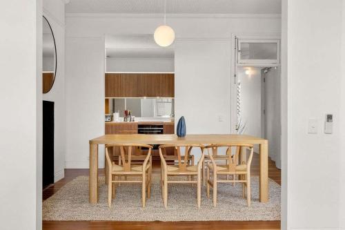 a dining room with a table and some chairs at Perfect Vacation Home in Dawes Point in Sydney