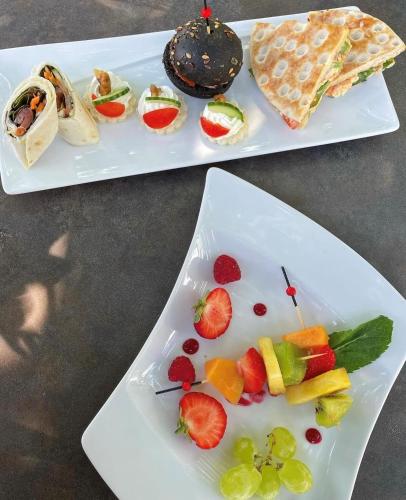 two plates of food with fruit on them on a table at Best Western Alexander Park Chambéry in Chambéry