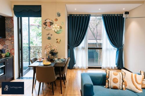 a living room with a blue couch and a table at High-ser Apartment -2BR - NiceView - Parking - Spacious - In center in Hanoi