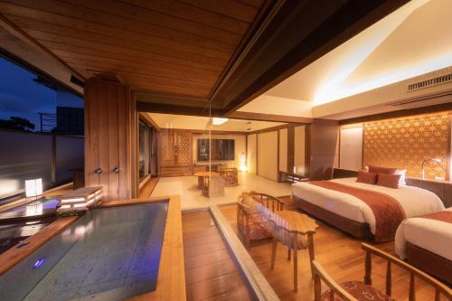 a hotel room with a bed and a swimming pool at Hakone Kamon in Hakone