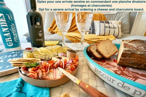 a table with a plate of food and a bottle of wine at ty loulou - Hyper centre in Concarneau