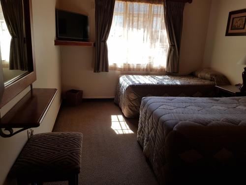 a hotel room with two beds and a window at Blyde Canyon, A Forever Resort in Matibidi
