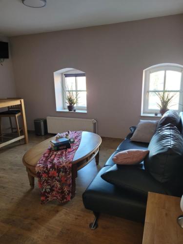 a living room with a couch and a table at Hotel Garni Kastanjehoff in Timmel