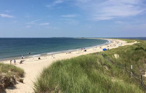 a group of people on a beach near the ocean at 1 Bedroom Nice Home In Munka-Ljungby in Munka-Ljungby