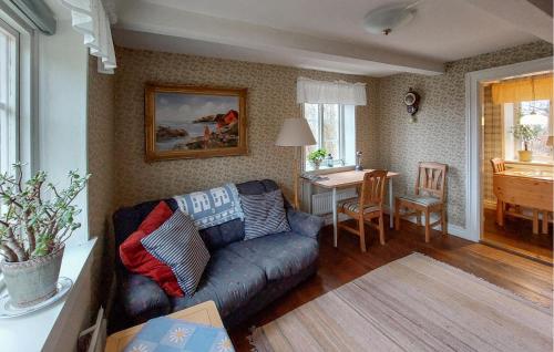 a living room with a couch and a table at 1 Bedroom Nice Home In Munka-Ljungby in Munka-Ljungby