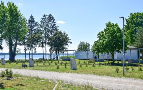 a cemetery with trees and a road at Lovely Home In Nowe Warpno in Nowe Warpno