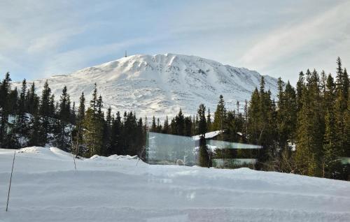 a snow covered mountain with a building in the foreground at Awesome Home In Rjukan With Sauna in Rjukan