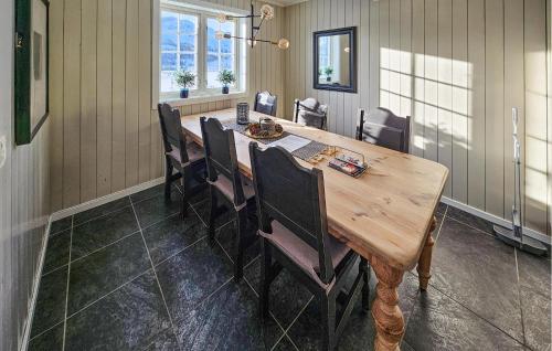 a dining room with a wooden table and chairs at Lovely Apartment In Rjukan With Wifi in Rjukan