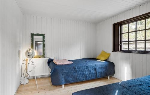 a bedroom with a blue bed and a mirror at Stunning Home In Martofte With Wifi in Martofte