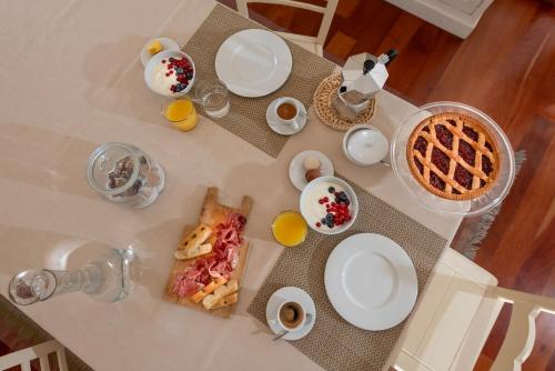 a table with breakfast foods and coffee on it at TulipHouse - Apartment Ballerina in Vezza d'Alba