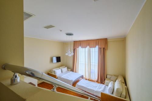 a hospital room with two beds and a window at Castello Mare Hotel in K'obulet'i