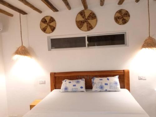 a bedroom with a bed with two pillows on it at Uroa House in Uroa