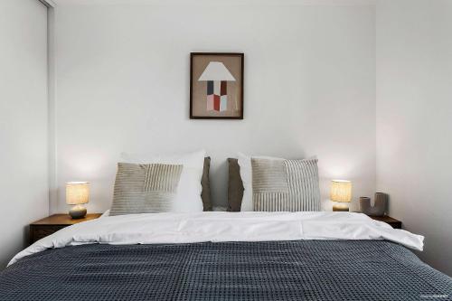 a bedroom with a large bed with two lamps at The Marina Suite Including 1x Free Private Parking Spot in Aarhus