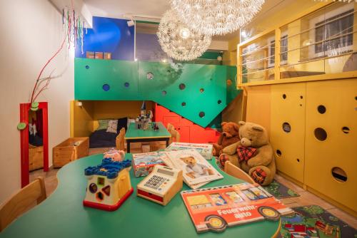 a room with a table with a teddy bear and books at Alpine Spa Residence in Bad Kleinkirchheim