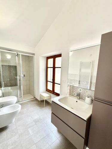 a bathroom with a sink and a toilet and a tub at Casa delle volte in Finale Ligure