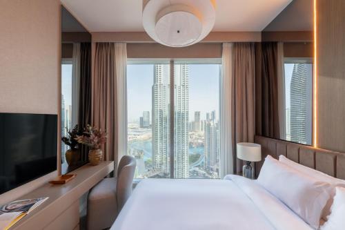 Una cama o camas en una habitación de Royal 4BR Burj Khalifa View Dubai Mall