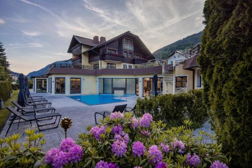 a house with a swimming pool in the yard at Alpine Spa Residence in Bad Kleinkirchheim