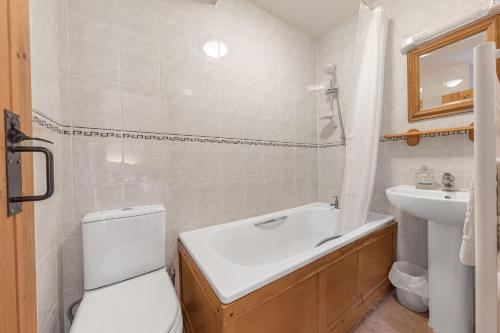 a bathroom with a white toilet and a sink at Rose Bank Cottage Coniston in Coniston