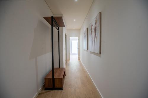 a hallway of a house with white walls and wooden floors at HAGAH Alojamentos in Guimarães