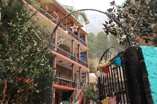 a building with balconies on the side of it at Chalo Chhalal Hotel & Cafe in Kasol