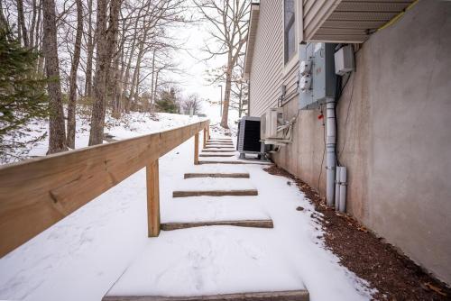 a snow covered sidewalk next to a building at Luxury House in Pocono Mountains in Tannersville