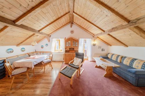 a living room with a blue couch and a table at Haus Antonia in Wallgau