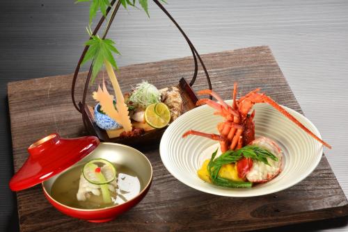 a wooden table with two plates of food on it at Hakone Kamon in Hakone