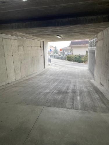 an empty parking lot with an open garage at Villa Irma in Chiesa in Valmalenco