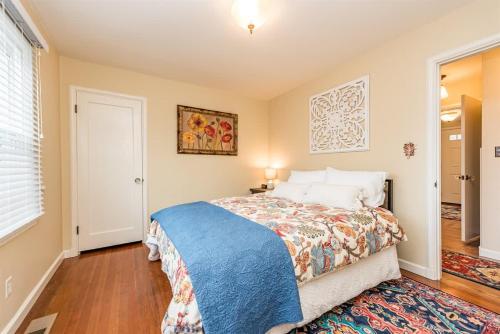 a bedroom with a bed with a blue blanket at Sq Urban Retreat in Sequim