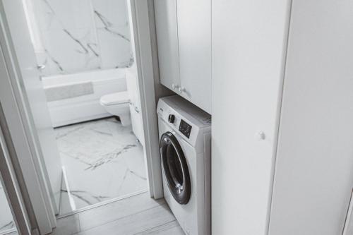 a washer and dryer in a bathroom at Lake View Apartment Iasi in Valea Lupului