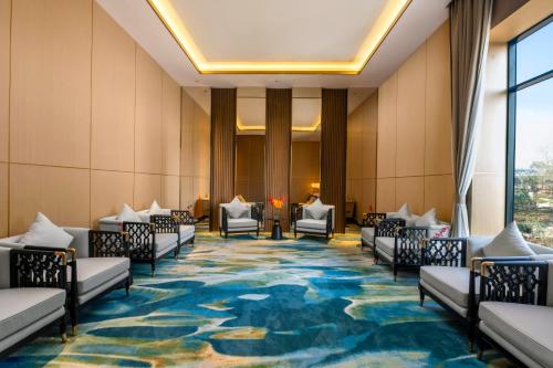 a hotel lobby with chairs and a large carpet at Amari Vientiane in Vientiane