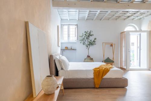 a bedroom with a bed in a room with white walls at Eos Retreat in Trastevere with pool in Rome
